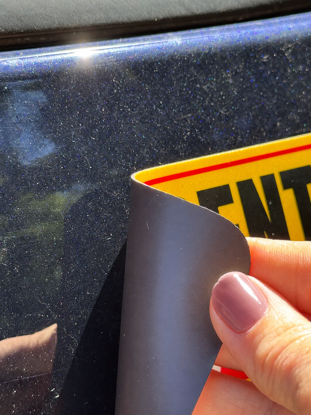 Curled corner on a vehicle magnetic sign caused by heat and improper storage