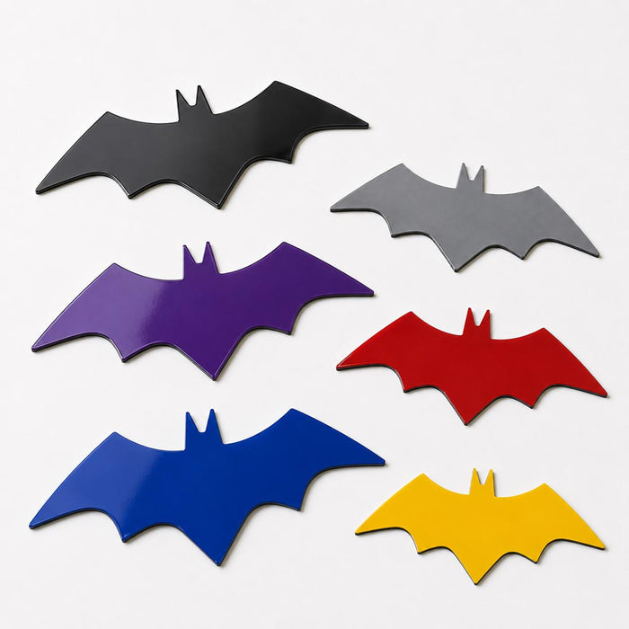 Set of six bat-shaped magnet blanls in different colors on a white background