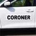 Car door with 'CORONER' decal on a white car
