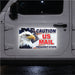 Car door with a 'Caution US Mail Frequent Stops' sign featuring an eagle and American flag.