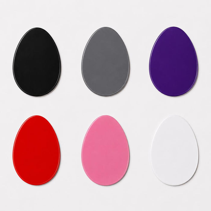 Set of six egg shaped magnets in black, gray, purple, red, pink, and white on a light gray background.