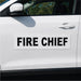 Car door with 'FIRE CHIEF' decal on a white car.