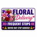 Floral delivery sign with colorful flowers and warning symbols.
