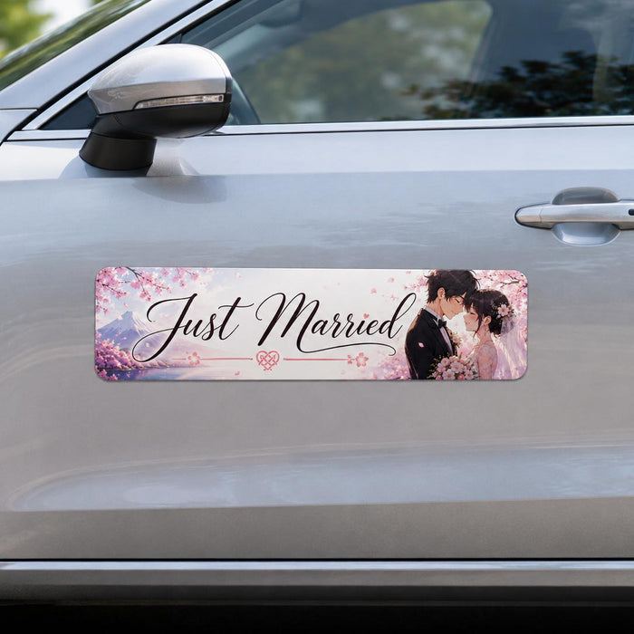 Car with a 'Just Married' magnetic sign featuring an image of a couple.