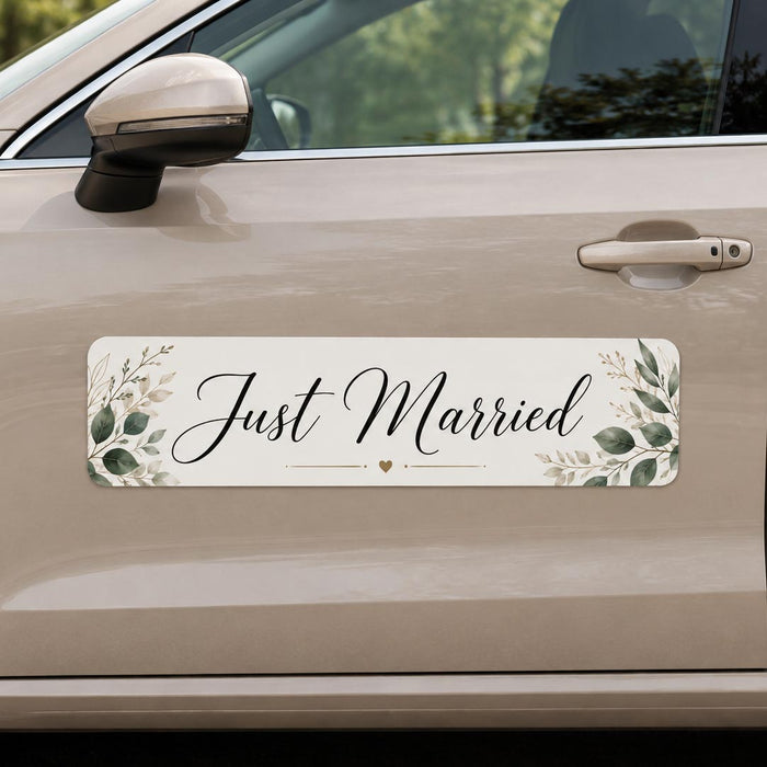 Car door with 'Just Married' decal featuring greenery