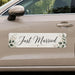 Car door with 'Just Married' decal featuring greenery