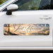 Car with a 'Just Married' decal featuring a cross and sunset design.