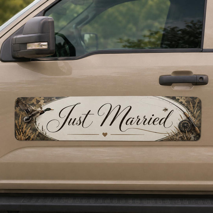 Beige vehicle with 'Just Married' decal on a nature-themed background