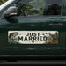 Decorative bumper sticker with 'Just Married' text on a car window.