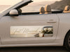 Car door with 'Just Married' sign and floral arrangement, beach in the background