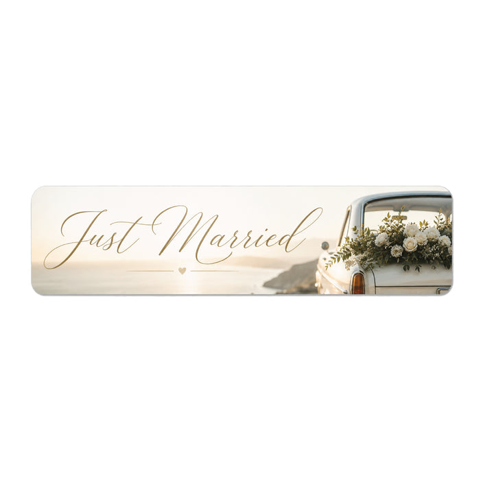 Decorative banner with 'Just Married' text and a car with flowers on a white background