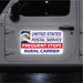 United States Postal Service sticker on a vehicle door with an eagle emblem.