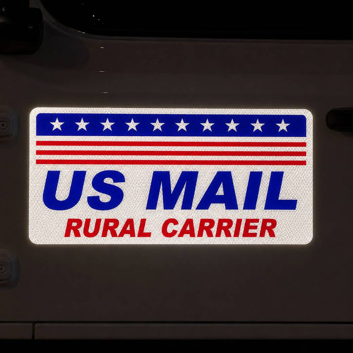 US Mail Rural Carrier magnetic decal sign on the front door of a white vehicle at night. 