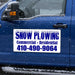 snow plowing magnetic sign with blue lettering on a blue truck. 