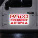 White vehicle with a reflective red and white caution frequent stops magnetic sign on the door.