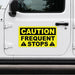 Yellow caution sign on a white vehicle door with 'CAUTION FREQUENT STOPS' text.
