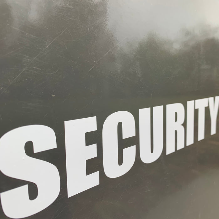 Security vinyl graphic installed on a car in white